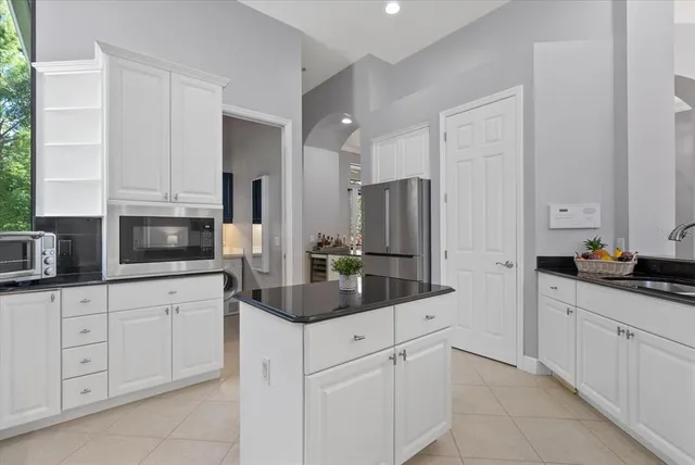 a living room with furniture a chandelier and a large window