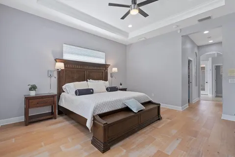 a bedroom with a bed and a lamp on dresser