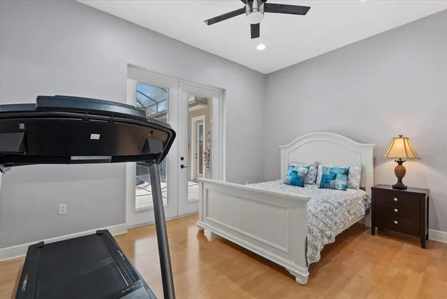 an aerial view of a residential houses with outdoor space and trees