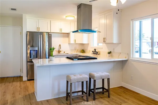 a kitchen with a table chairs refrigerator and cabinets