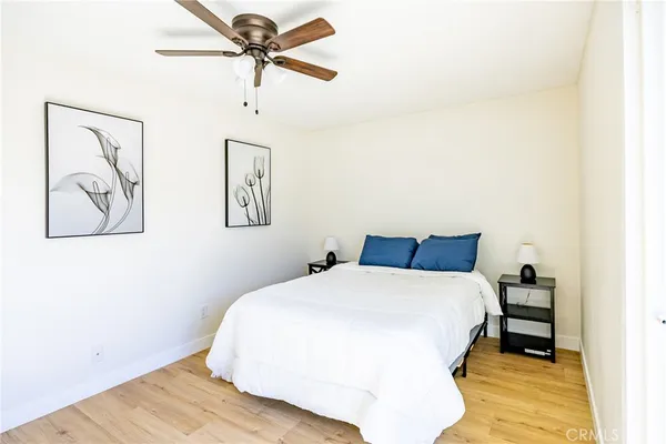 a bedroom with a bed and a painting on the wall