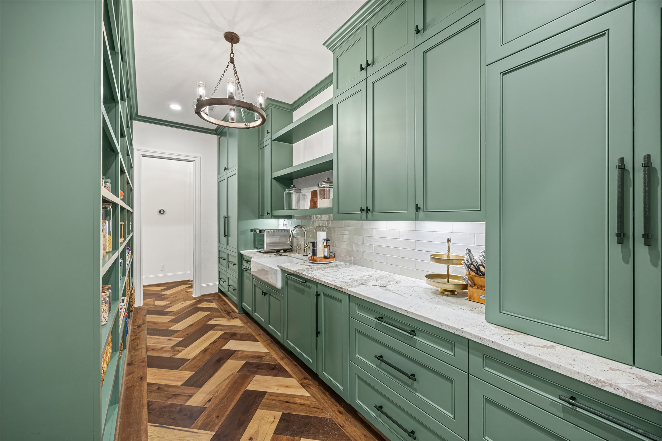 19314 Chateau Ridge Court Tomball, TX 77377 - Photo 11 of 50 Expansive behind-the-kitchen walk-through pantry with seamless flow, a dedicated prep sink, and panel-ready fridge, dishwasher, and ice maker.