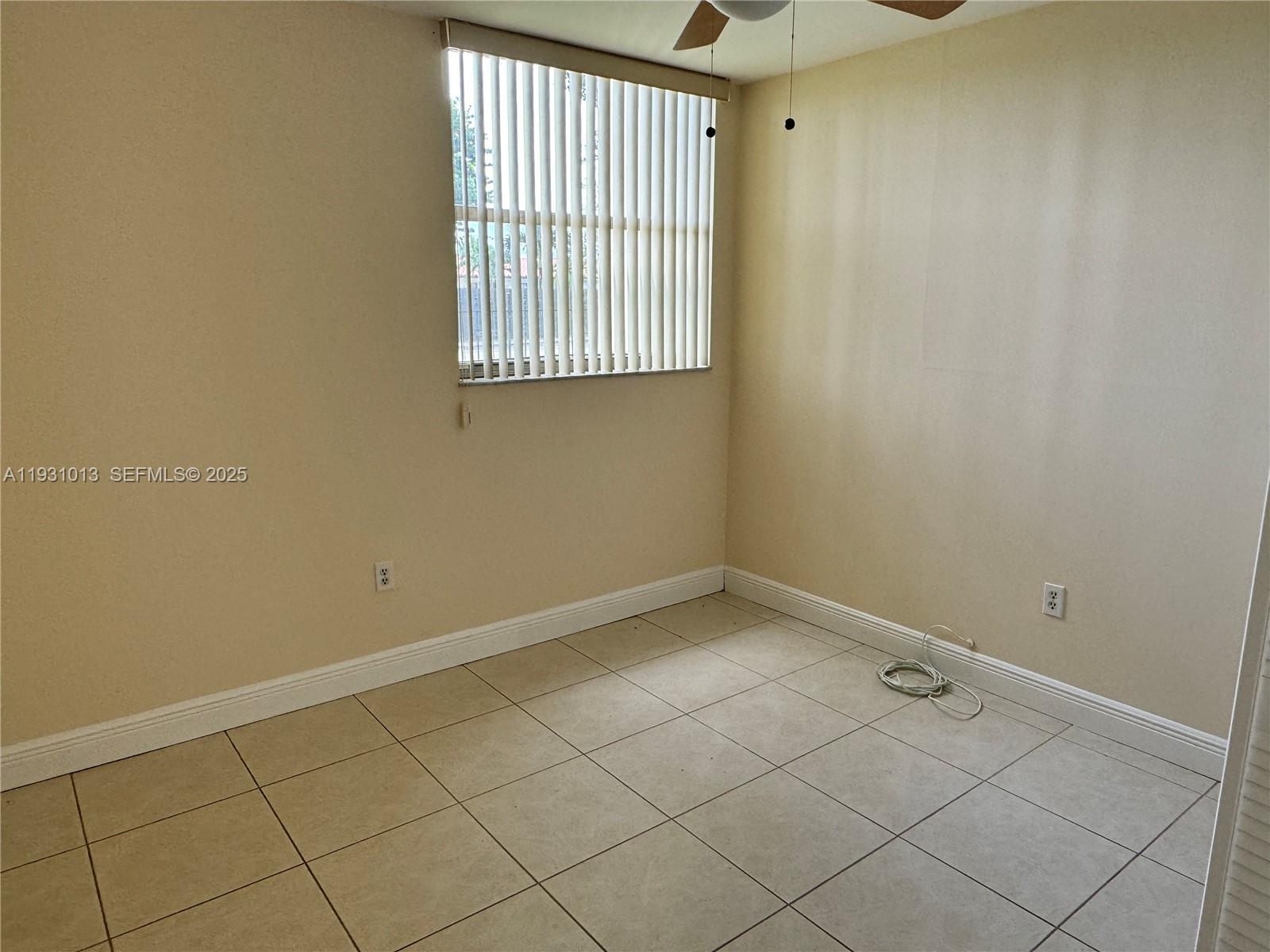 9411 Southwest 4th Street, Unit 111 Miami, FL 33174 - Photo 13 of 28 a view of an empty room with a window