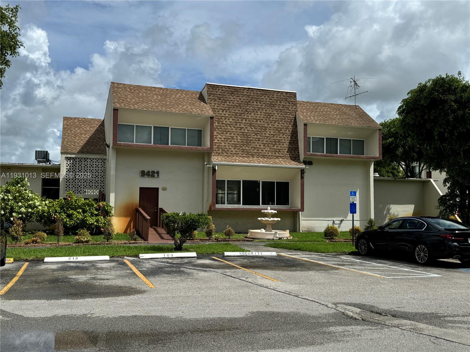 9411 Southwest 4th Street, Unit 111 Miami, FL 33174 - Photo 17 of 28 a front view of a house with a yard and garage
