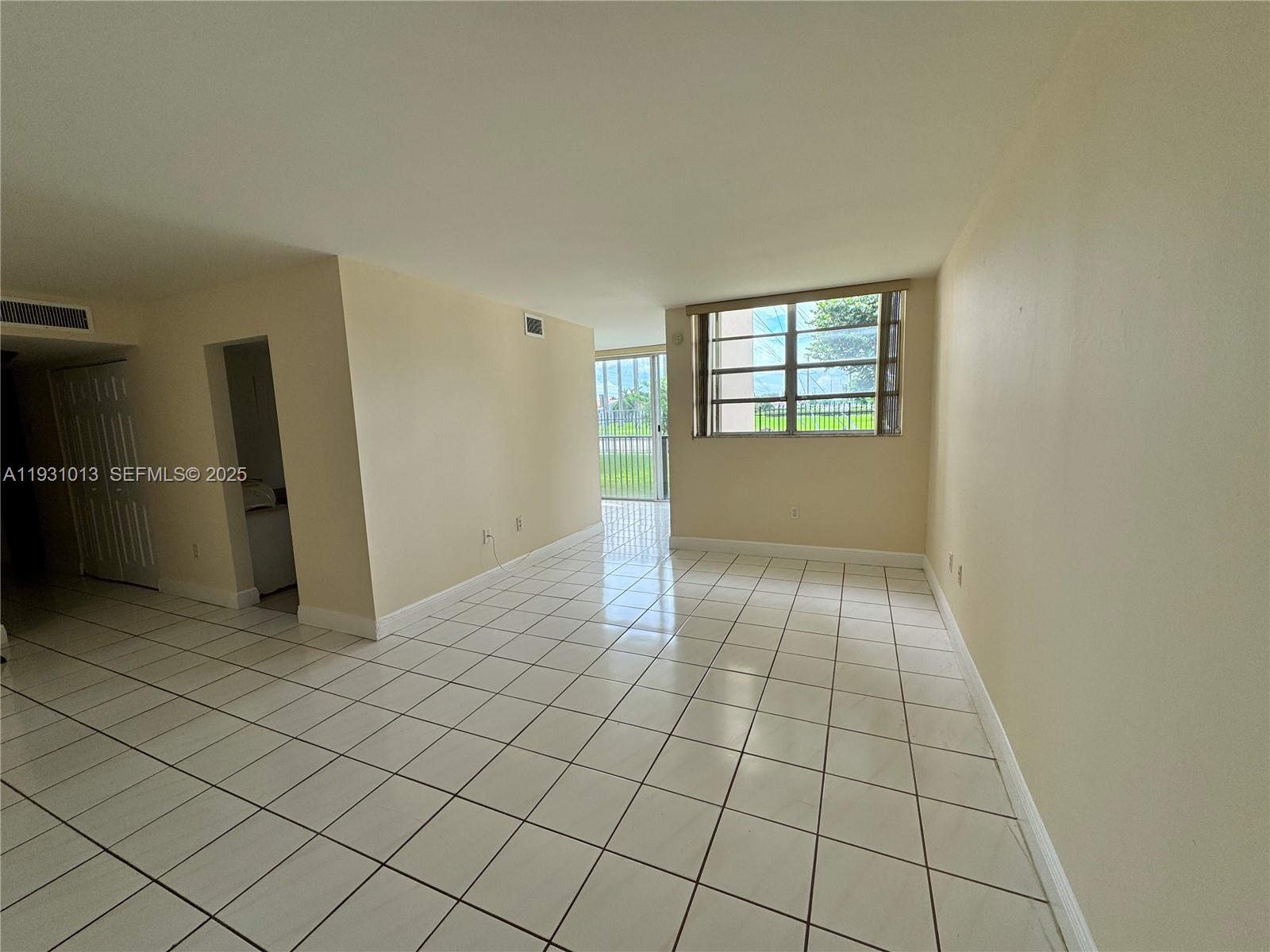 9411 Southwest 4th Street, Unit 111 Miami, FL 33174 - Photo 2 of 28 an empty room with windows