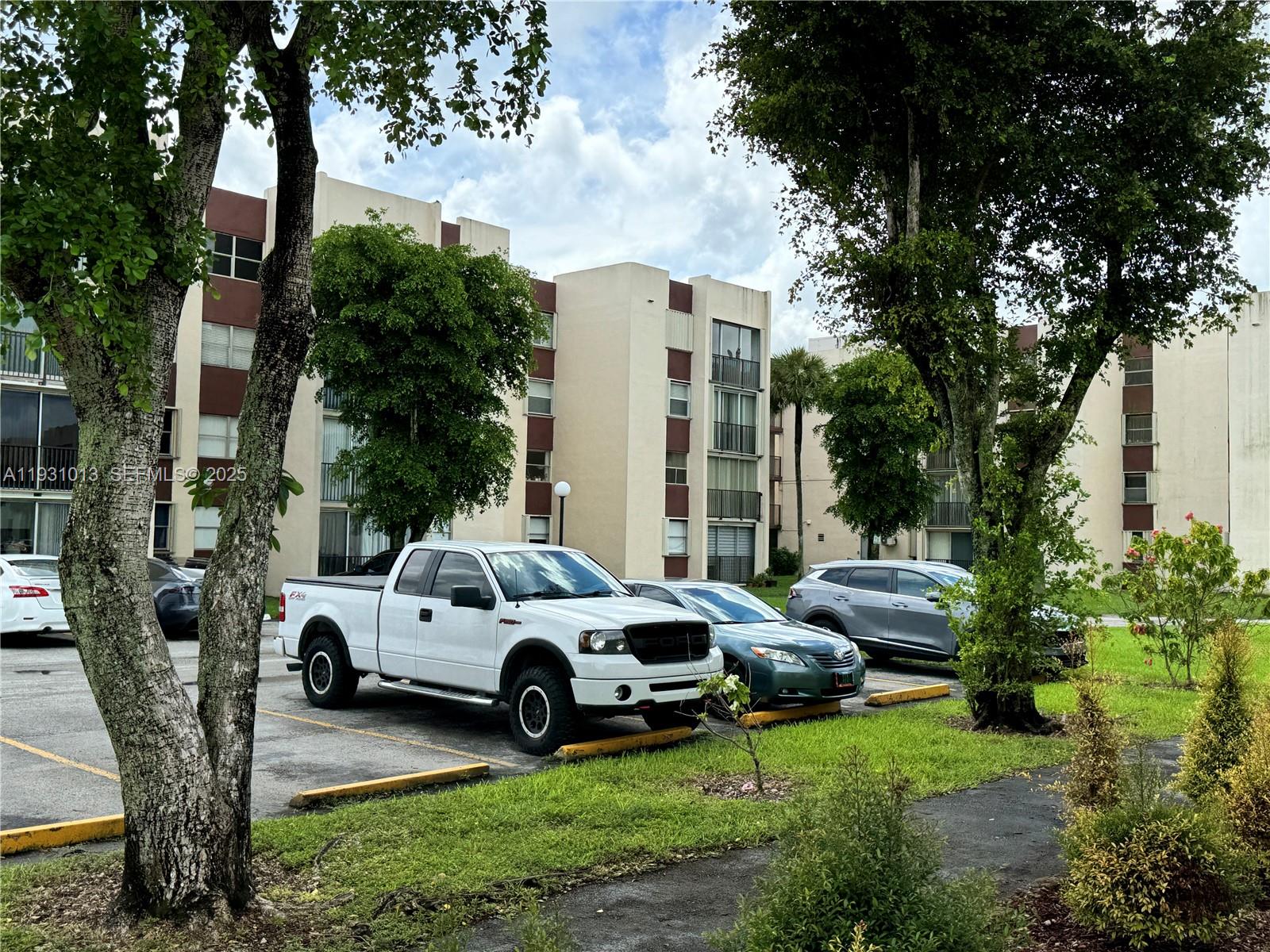 9411 Southwest 4th Street, Unit 111 Miami, FL 33174 - Photo 27 of 28 a view of a cars park in front of a house