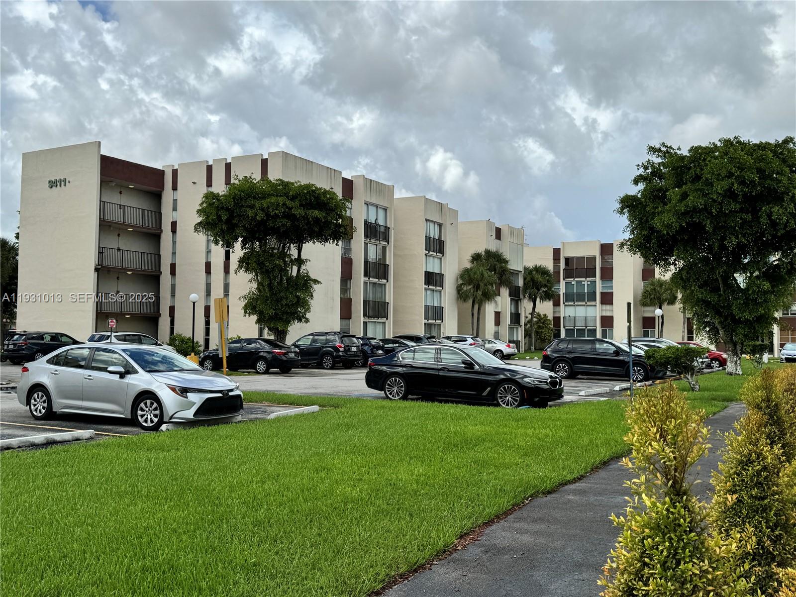 9411 Southwest 4th Street, Unit 111 Miami, FL 33174 - Photo 28 of 28 a car parked in the garden in front of a building