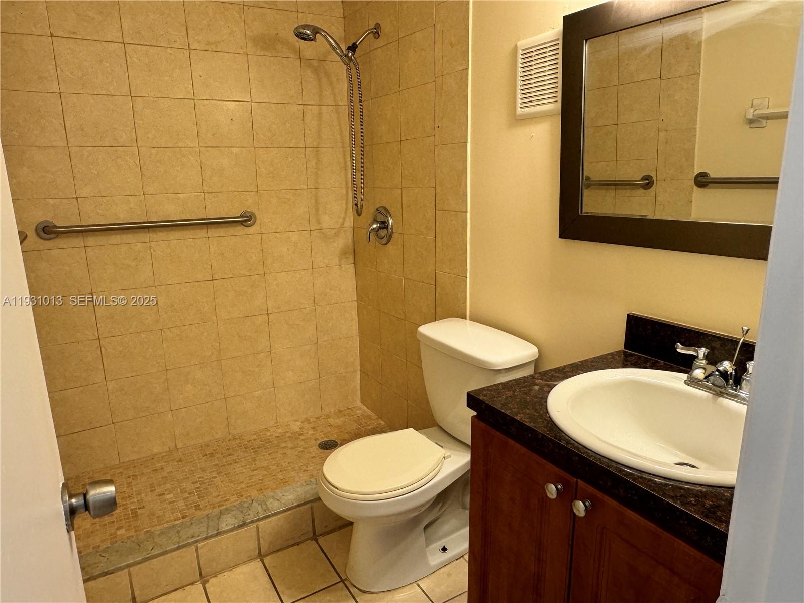 9411 Southwest 4th Street, Unit 111 Miami, FL 33174 - Photo 6 of 28 a bathroom with a sink a toilet and shower