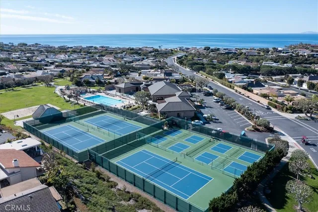 an aerial view of a tennis ground and a houses