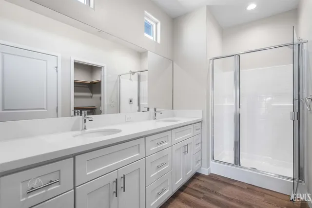 a bathroom with a double vanity sink and a mirror