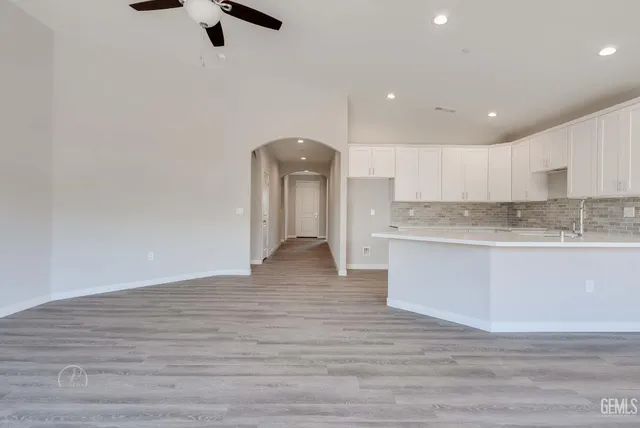 a view of kitchen with granite countertop cabinets and wooden floor