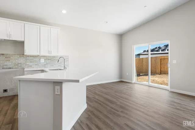 a kitchen with wooden floor and a sink