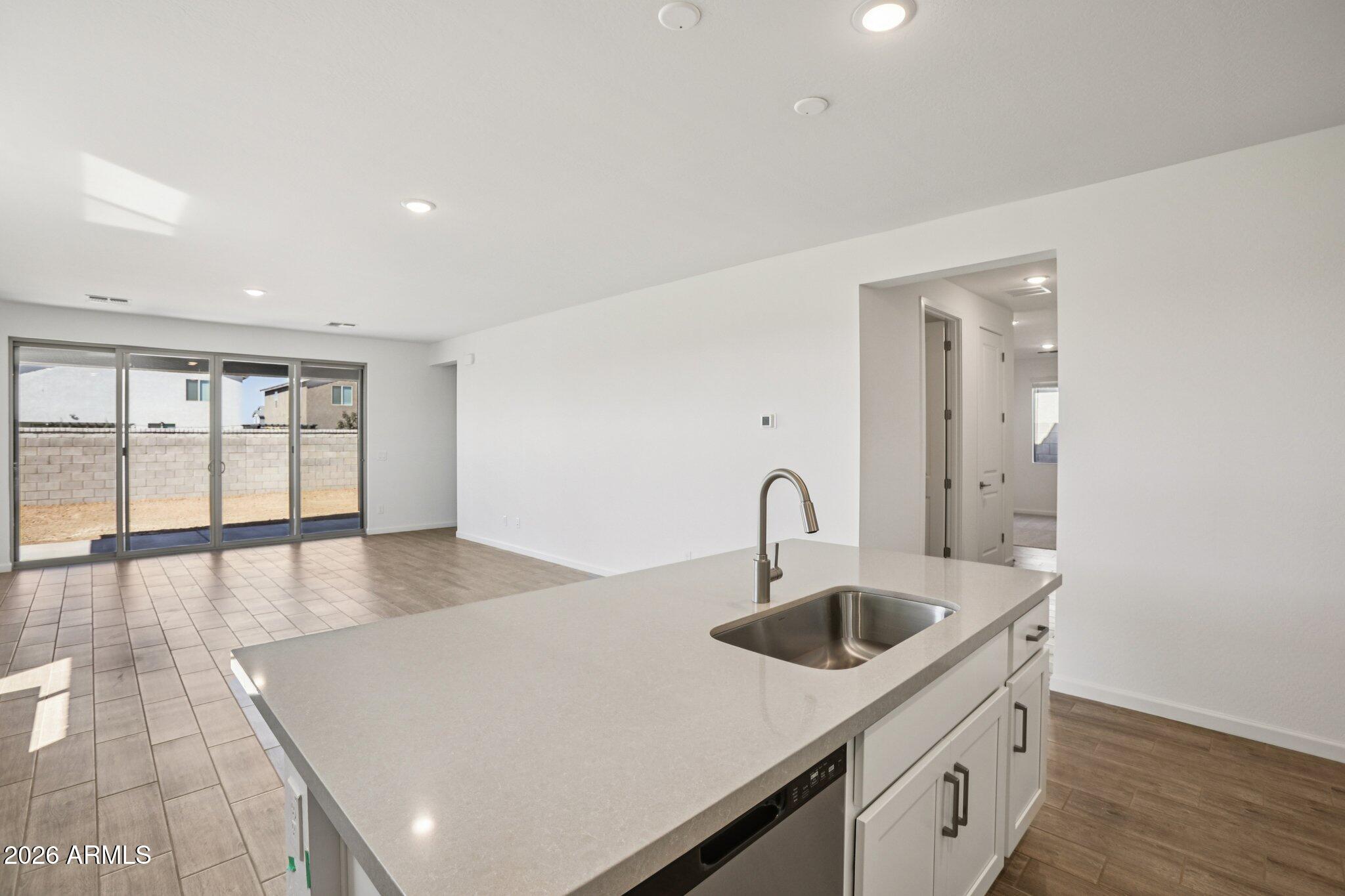 32094 Buckaroo Road San Tan Valley, AZ 85140 - Photo 12 of 46 a kitchen with a sink and chandelier