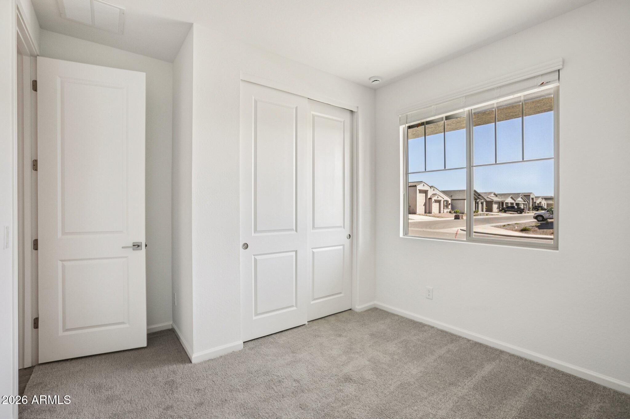 32094 Buckaroo Road San Tan Valley, AZ 85140 - Photo 13 of 46 a view of an empty room with window