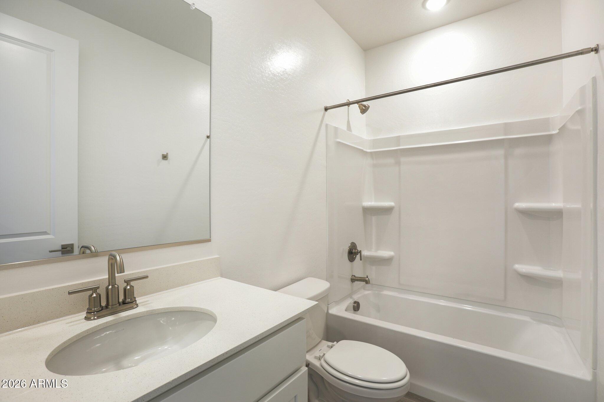 32094 Buckaroo Road San Tan Valley, AZ 85140 - Photo 15 of 46 a bathroom with a sink toilet and shower