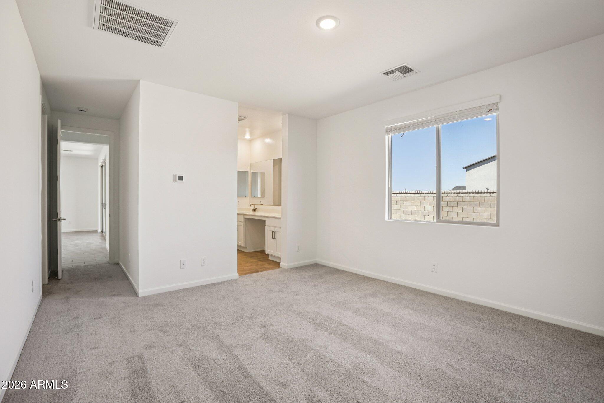 32094 Buckaroo Road San Tan Valley, AZ 85140 - Photo 26 of 46 a view of an empty room with closet and a window