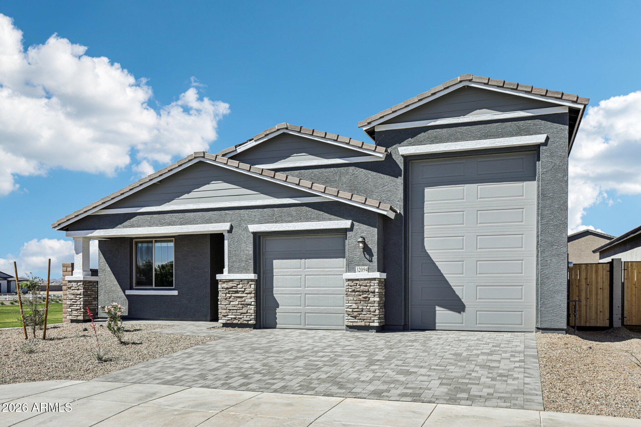 32094 Buckaroo Road San Tan Valley, AZ 85140 - Photo 3 of 46 a front view of a house with garage