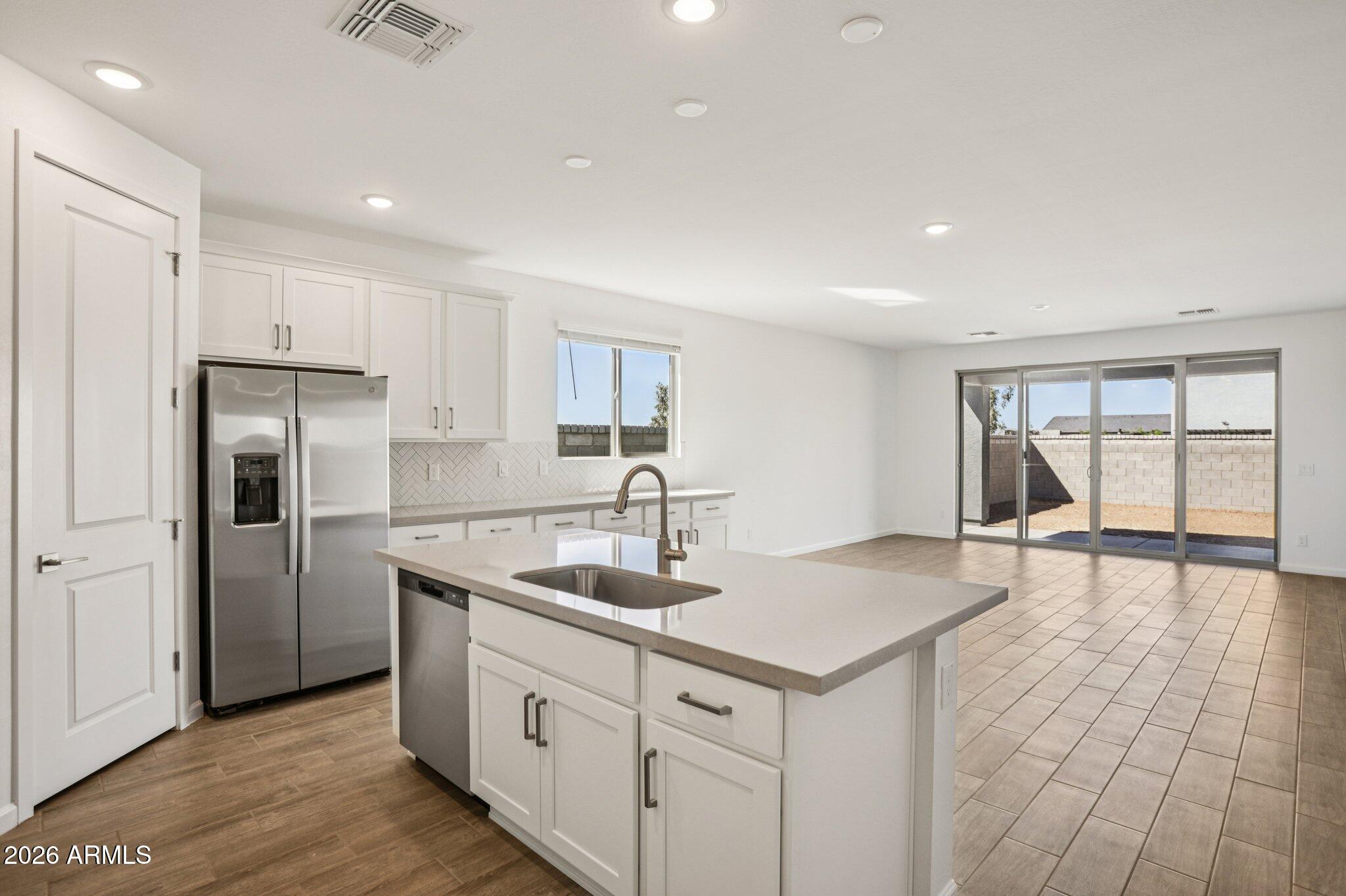 32094 Buckaroo Road San Tan Valley, AZ 85140 - Photo 10 of 46 a kitchen with kitchen island a sink and appliances