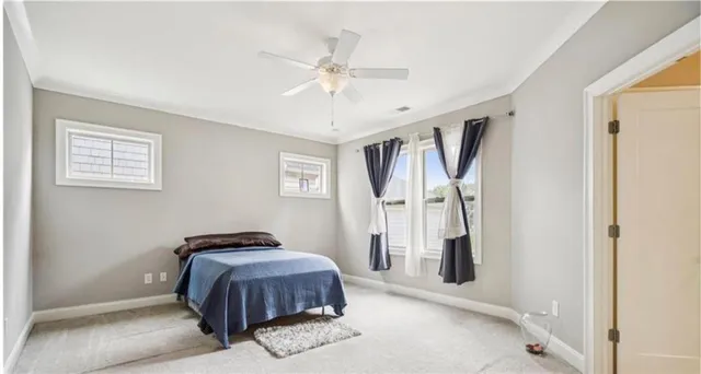 a spacious bedroom with a bed and a window