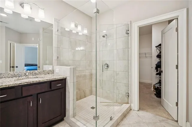 a bathroom with a shower sink and mirror