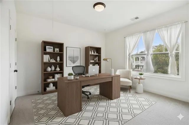 a view of a workspace with furniture and a window