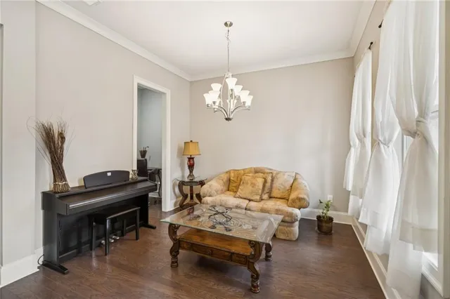 a living room with furniture and a chandelier
