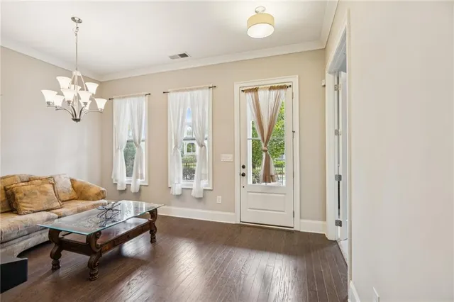 a living room with furniture and a chandelier