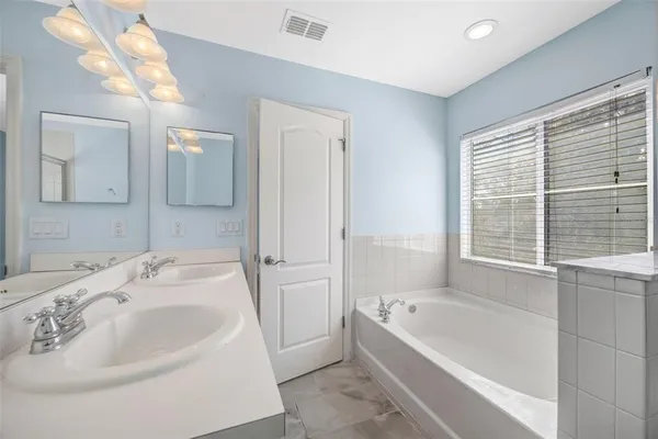 a bathroom with a bathtub and a sink