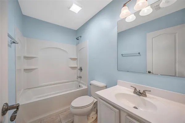 a bathroom with a sink toilet vanity and shower