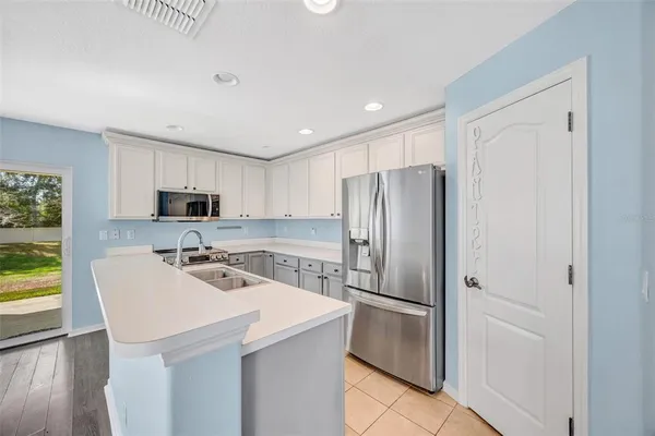 a kitchen with stainless steel appliances a refrigerator stove microwave and sink