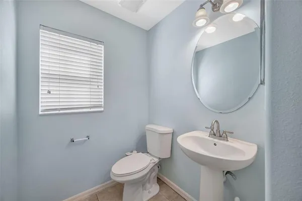 a bathroom with a sink toilet and a mirror