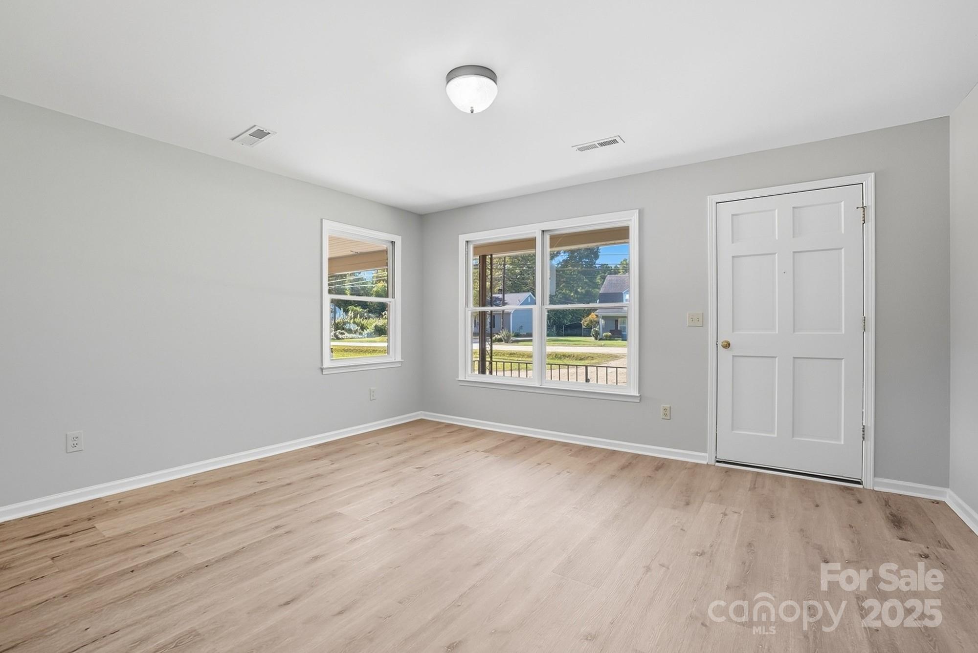 3230 West Innes Street Salisbury, NC 28144 - Photo 11 of 44 a view of an empty room with a window and wooden floor