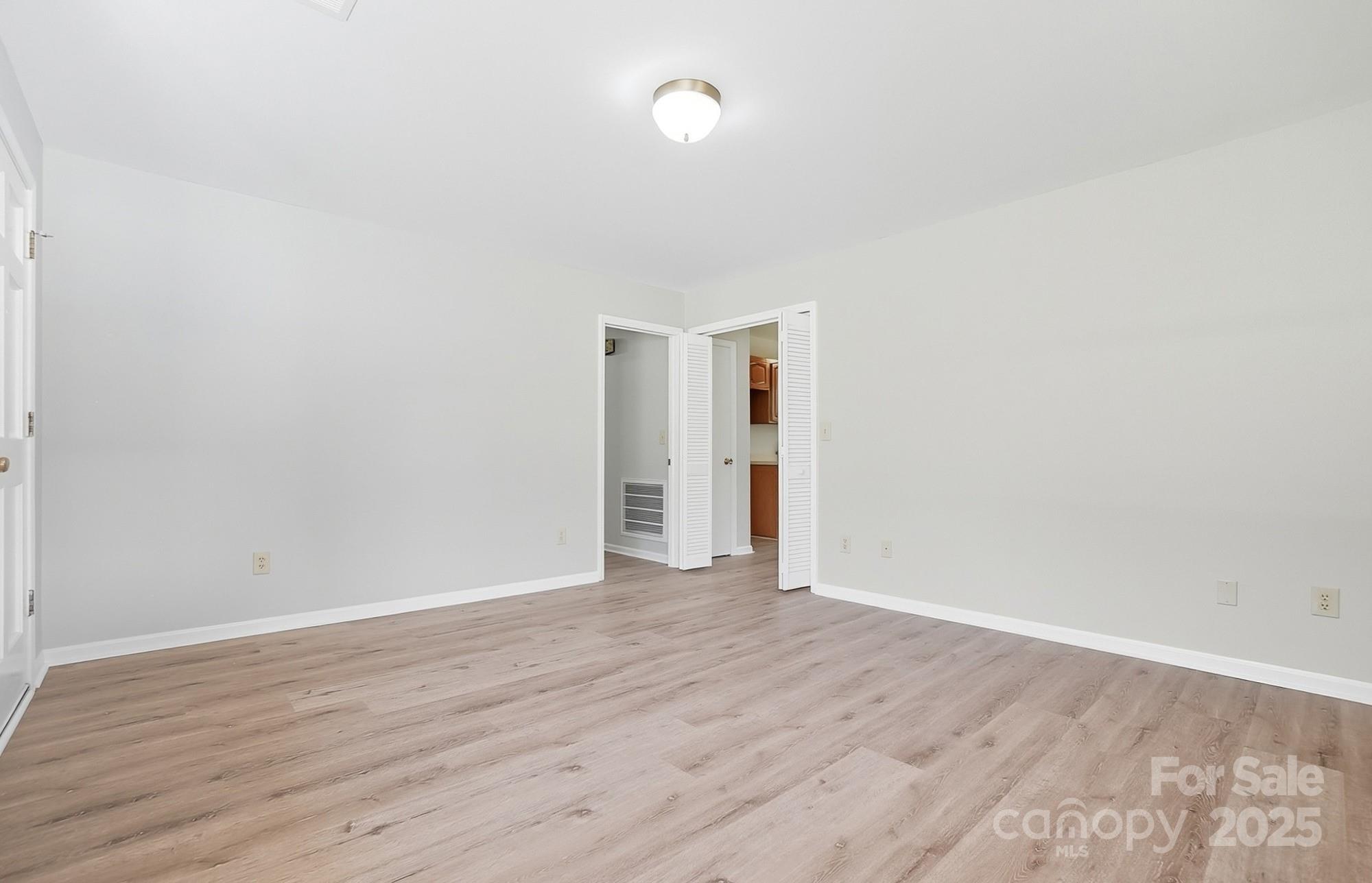 3230 West Innes Street Salisbury, NC 28144 - Photo 15 of 44 a view of an empty room with wooden floor