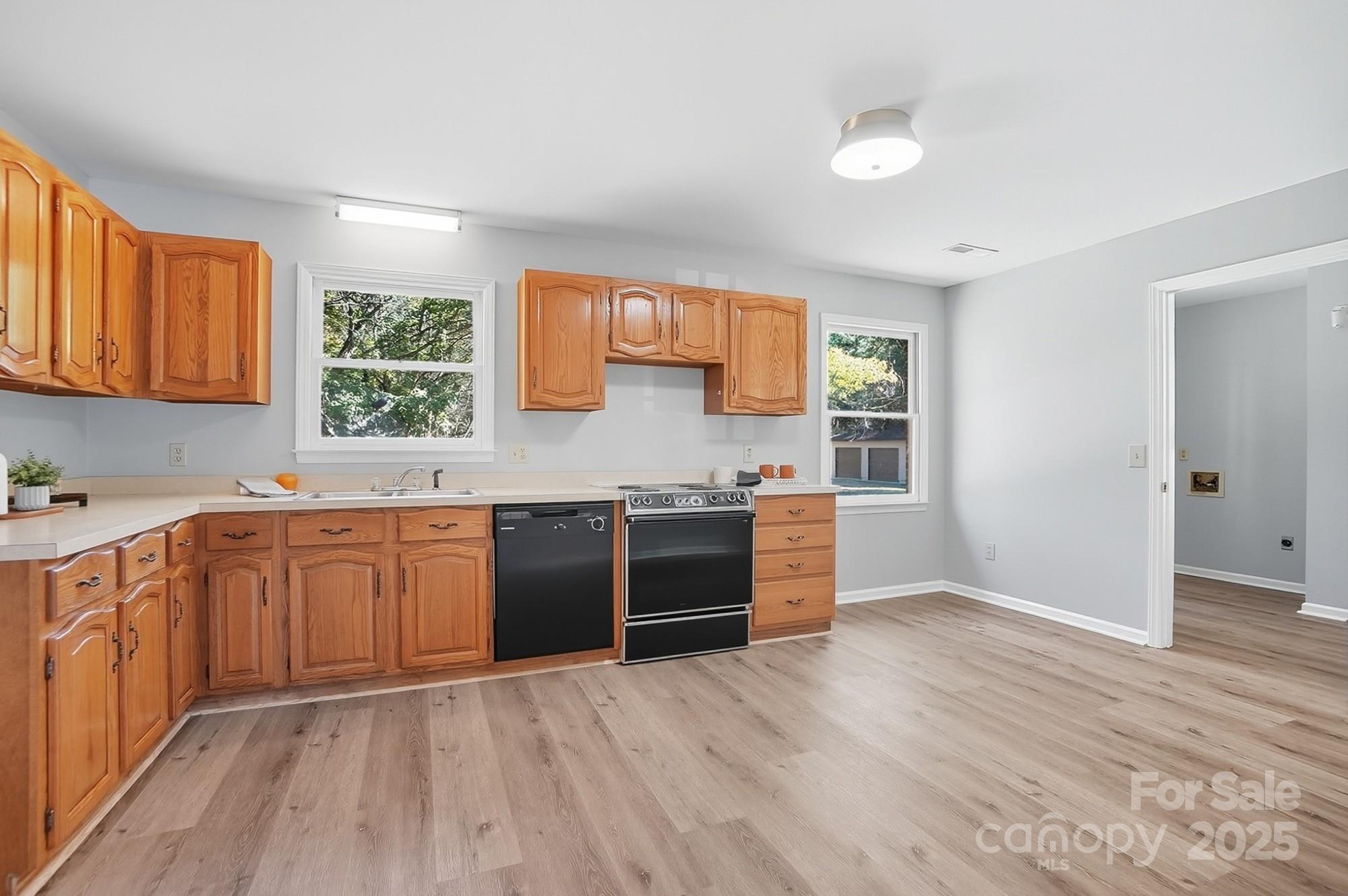 3230 West Innes Street Salisbury, NC 28144 - Photo 16 of 44 a kitchen with stainless steel appliances granite countertop a stove a sink and a refrigerator