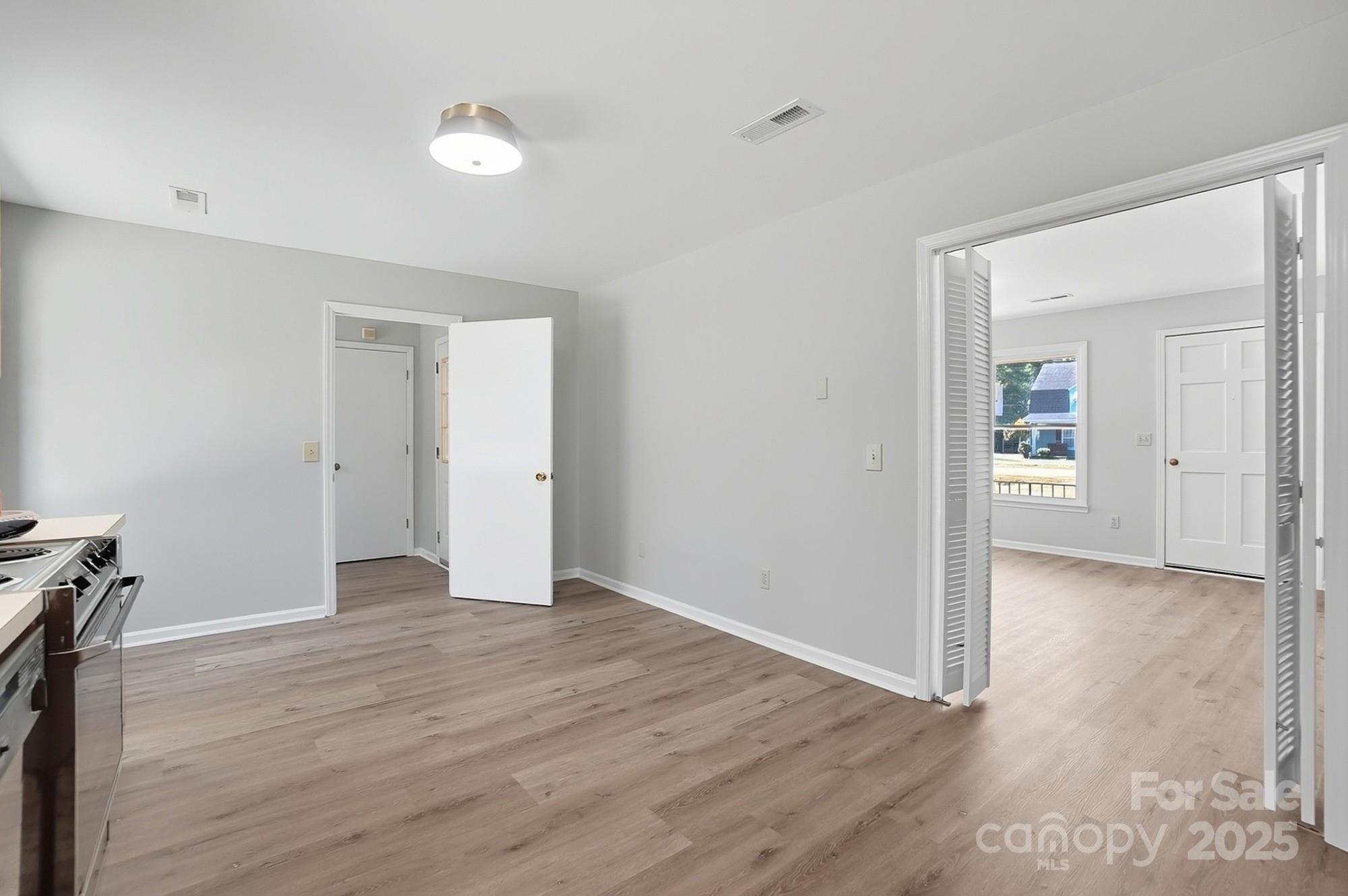 3230 West Innes Street Salisbury, NC 28144 - Photo 20 of 44 an empty room with wooden floor and windows