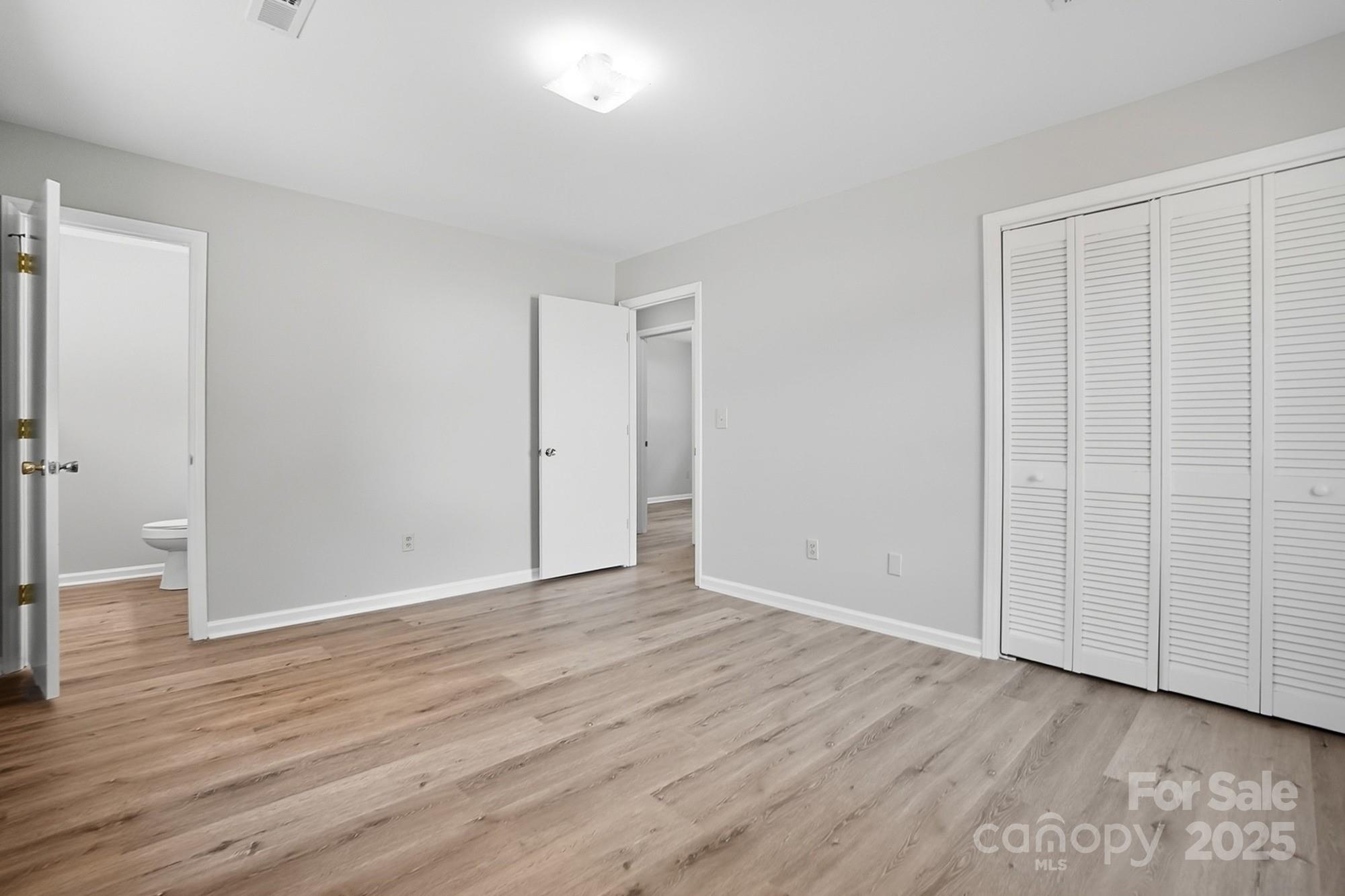 3230 West Innes Street Salisbury, NC 28144 - Photo 25 of 44 a view of an empty room with wooden floor and closet area
