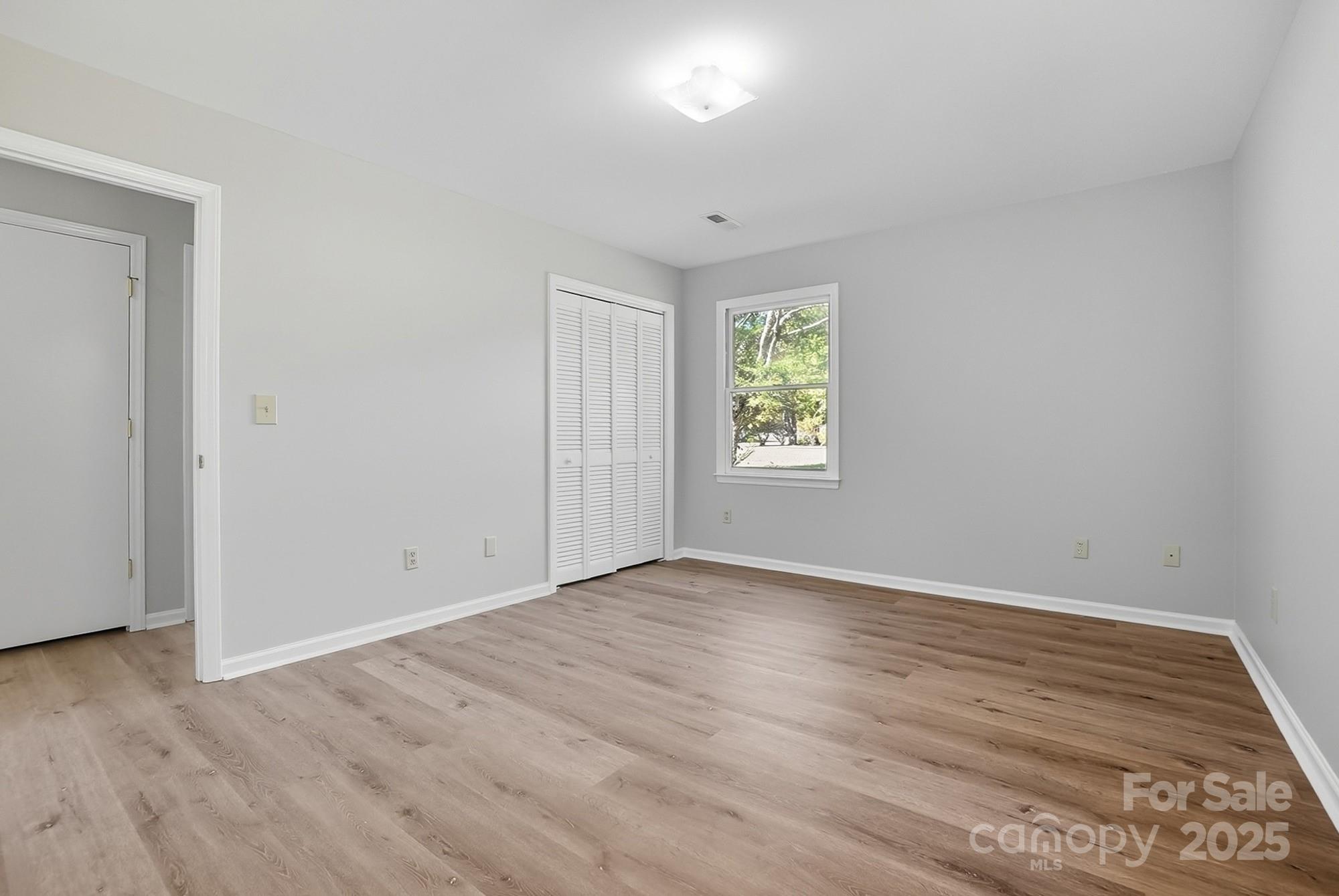 3230 West Innes Street Salisbury, NC 28144 - Photo 26 of 44 an empty room with wooden floor and windows