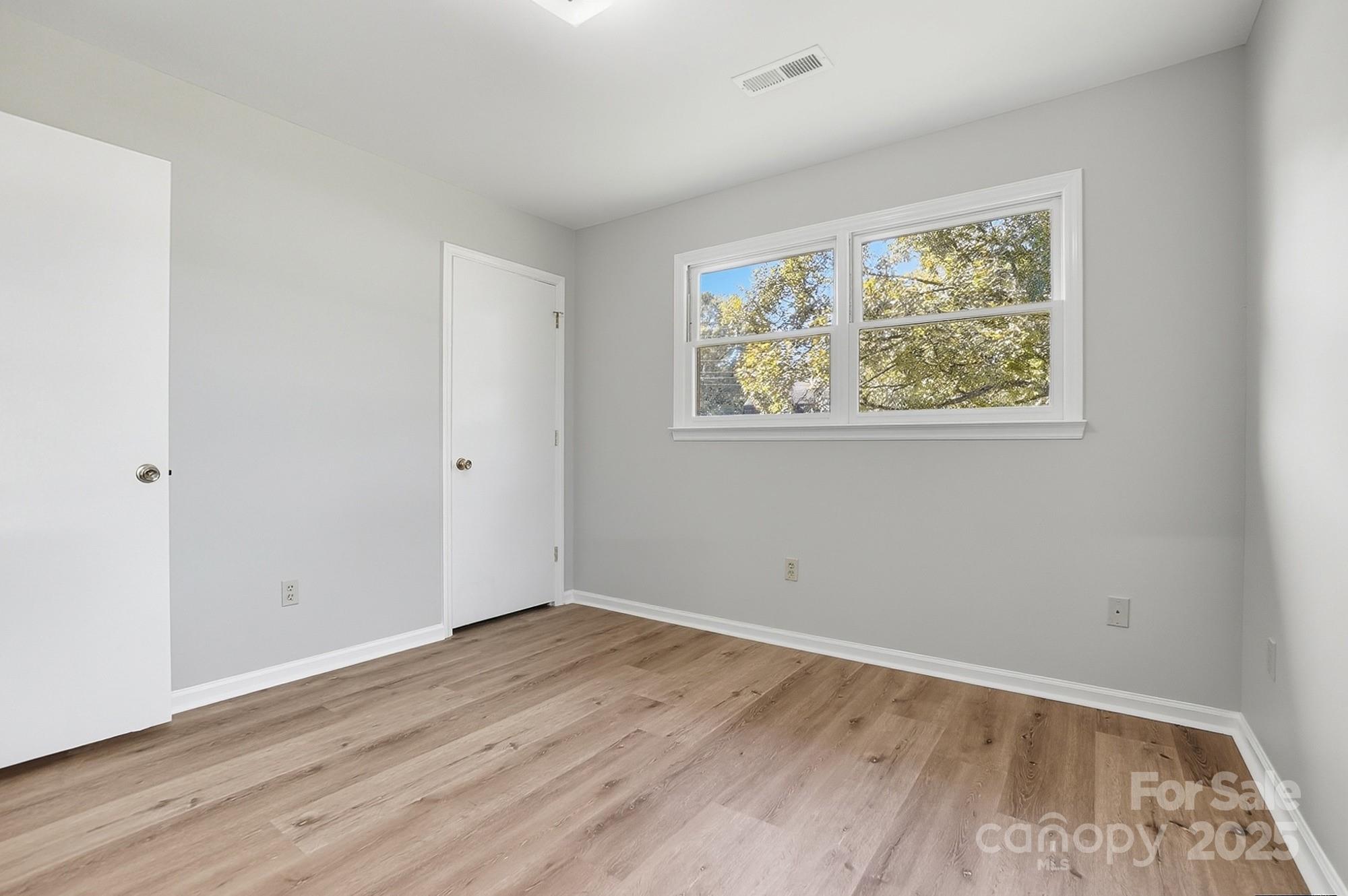 3230 West Innes Street Salisbury, NC 28144 - Photo 30 of 44 an empty room with wooden floor and window