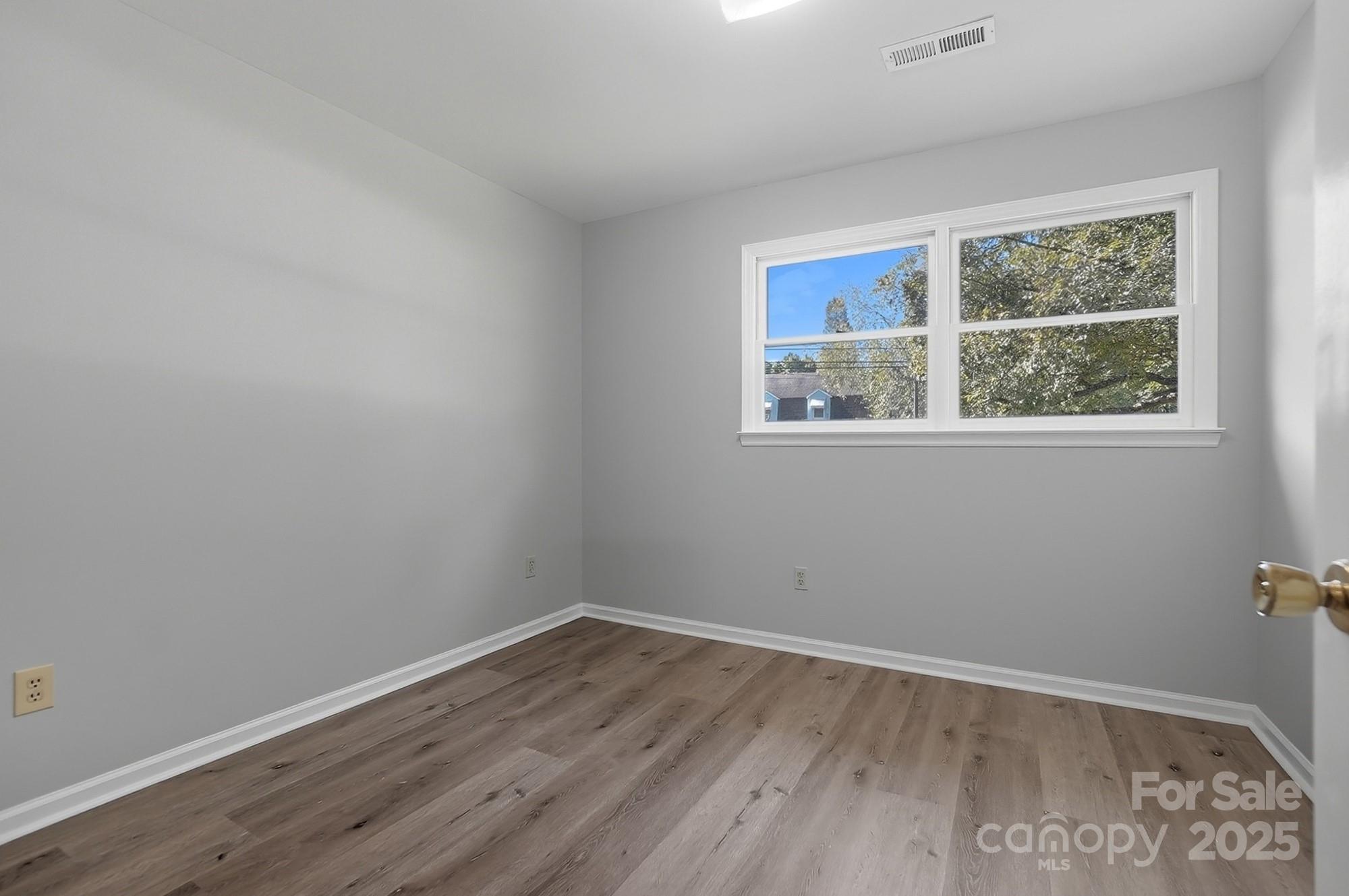3230 West Innes Street Salisbury, NC 28144 - Photo 33 of 44 wooden floor in an empty room with a window