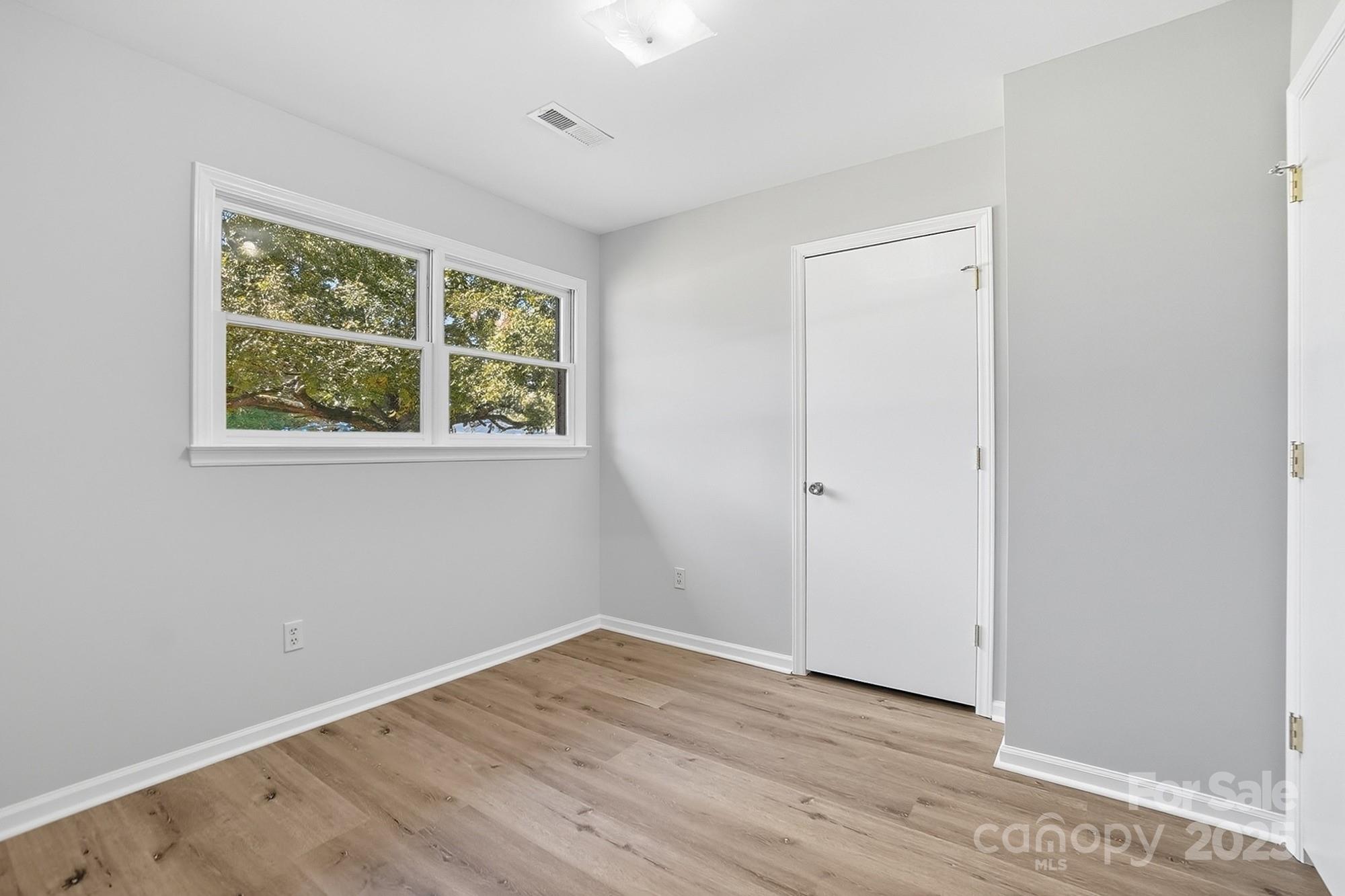 3230 West Innes Street Salisbury, NC 28144 - Photo 34 of 44 an empty room with wooden floor and windows