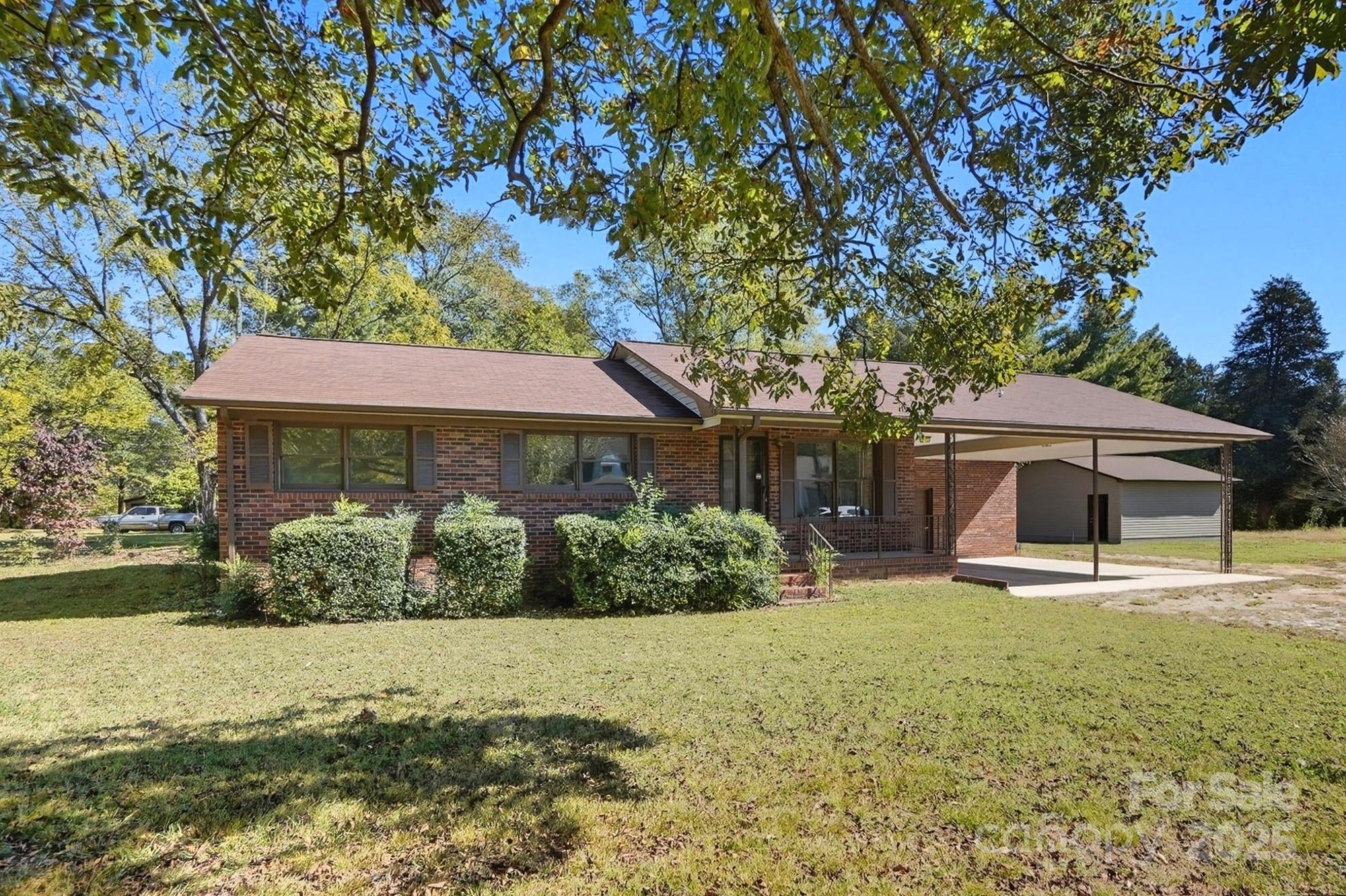 3230 West Innes Street Salisbury, NC 28144 - Photo 9 of 44 a front view of a house with a yard and garage