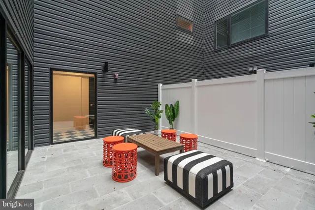 a backyard of a house with sofas
