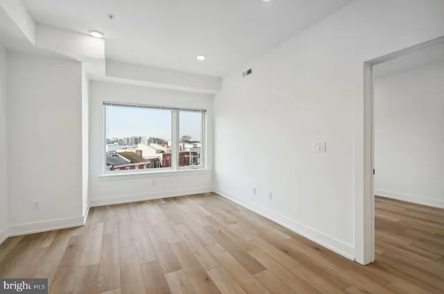 wooden floor in a hall with an empty room