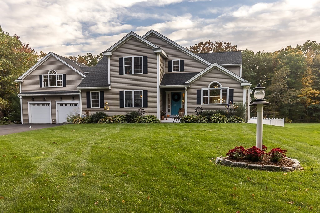 a front view of a house with a yard and garage