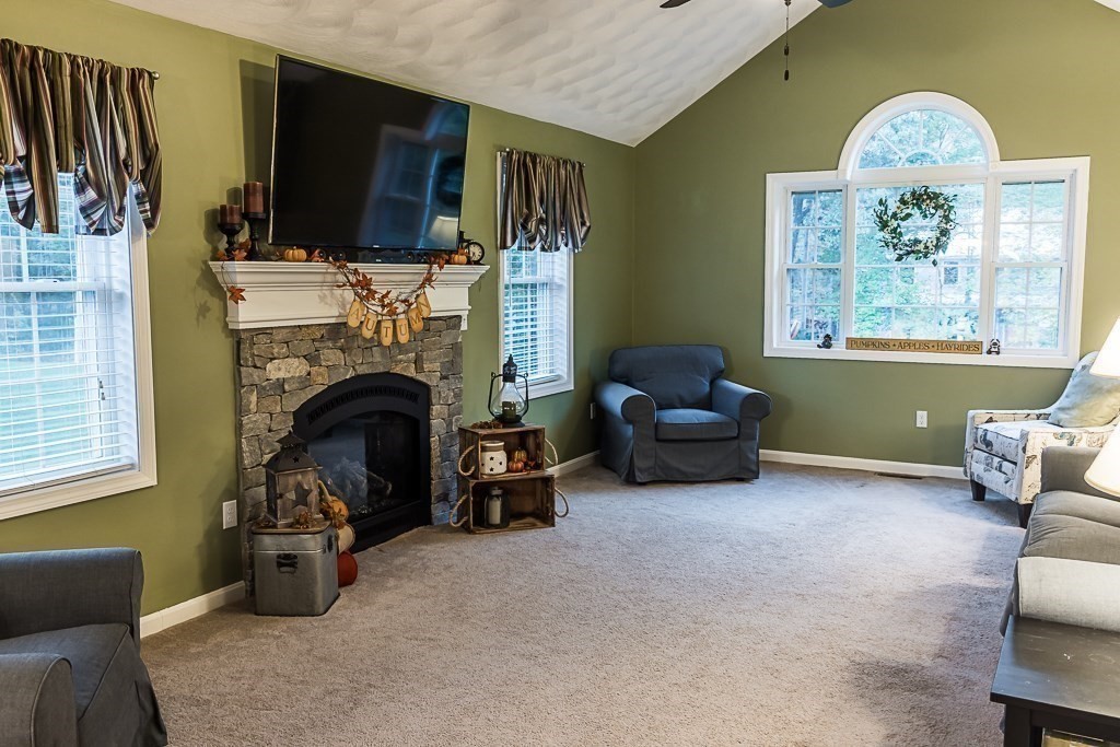 77 Baker Road Salisbury, MA 01952 - Photo 16 of 42 a living room with furniture and a fireplace