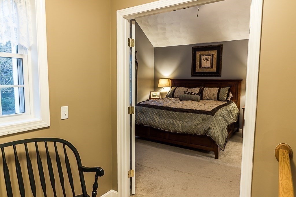 77 Baker Road Salisbury, MA 01952 - Photo 25 of 42 a bedroom with a bed and a painting on the wall