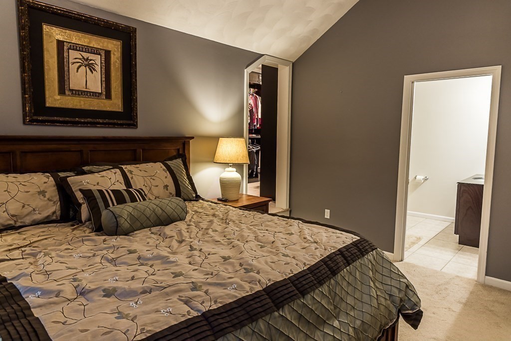 77 Baker Road Salisbury, MA 01952 - Photo 27 of 42 a bedroom with a large bed and a lamp