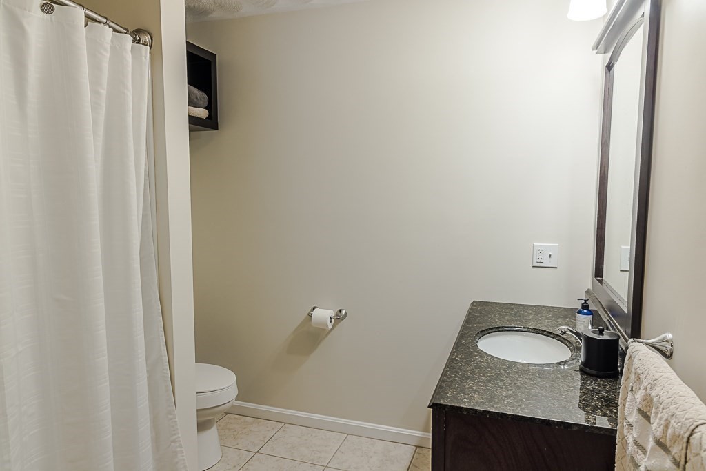 77 Baker Road Salisbury, MA 01952 - Photo 28 of 42 a bathroom with a granite countertop sink toilet and shower