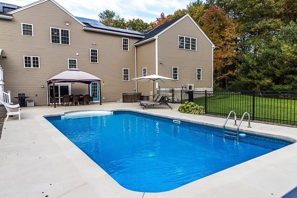 77 Baker Road Salisbury, MA 01952 - Photo 6 of 42 a view of a house with a swimming pool and sitting area