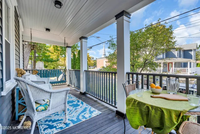a view of a patio with table and chairs with wooden fence and plants